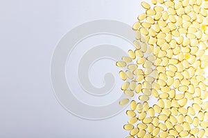 Omega-3 on light gray background with copy space horizontal shot. Fish oil on a light background. Yellow capsules with