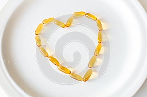 Omega 3 pills in a shape of heart photo