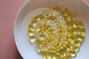 Omega-3 pills and vitamin D pills supplements placed on a plate