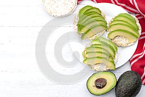 Omega 3 rich foods, vegan diet and nutritious healthy food concept with raw avocado fruits and slices on rice cake sandwiches on