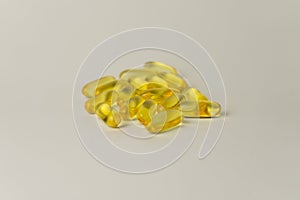 Omega-3-rich wild salmon and fish oil capsules against a gentle off-white background.