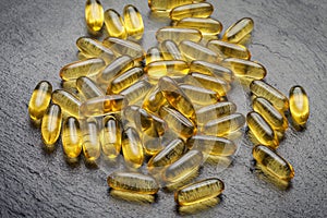 Omega 3. Transparent fish oil capsules on a black background