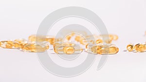 Omega 3 yellow soft gel pills isolated on white background.