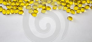 Omega 3 capsules on white background Fish oil Yellow softgels Vitamin D, E, A supplement