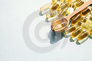 Yellow nutritional supplement pills full of Omega 3 fatty acids.