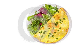 Omelet with fresh mixed salad leaves. top view. isolated