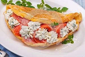 Omelet with lightly salted salmon and cream cheese and fresh herbs