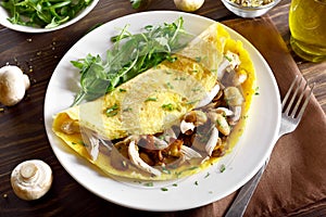 Omelet with mushrooms, chicken meat, greens