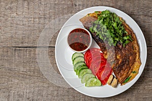 Omelet with mussels. Popular Thai food served with fresh vegetables and sauce on a plate. The view from the top. Copy-space.