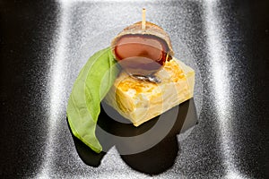 Omelet, tomato and anchovy pintxo with basil photo