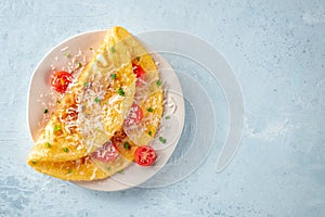 An omelet with tomato and parsley, eggs for breakfast, a healthy vegetarian dish