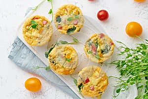 Omelet with tomatoes and bacon, baked eggs with spinach and broccoli, top view, keto, ketogenic diet