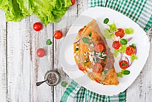 Omelet with tomatoes, parsley and feta cheese