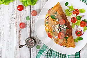 Omelet with tomatoes, parsley and feta cheese