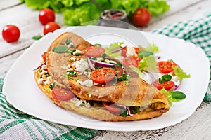 Omelet with tomatoes, parsley and feta cheese