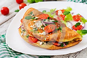 Omelet with tomatoes, parsley and feta cheese