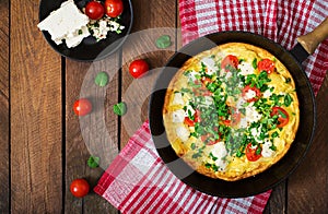 Omelet with tomatoes, parsley and feta cheese