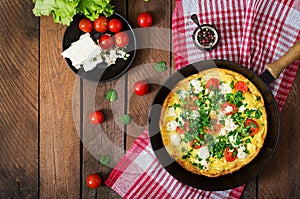 Omelet with tomatoes, parsley and feta cheese