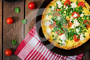 Omelet with tomatoes, parsley and feta cheese