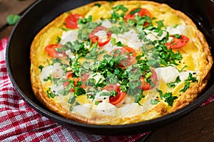 Omelet with tomatoes, parsley and feta cheese