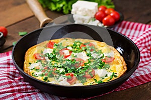 Omelet with tomatoes, parsley and feta cheese