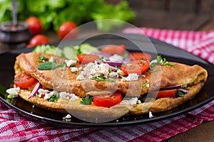 Omelet with tomatoes, parsley and feta cheese