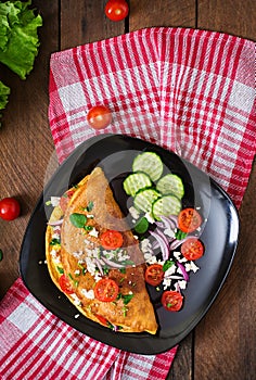 Omelet with tomatoes, parsley and feta cheese