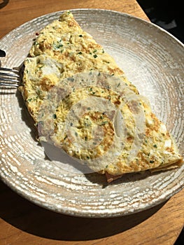 Omelet with vegetables and bacon and coffee latte with cinnamon