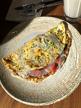 Omelet with vegetables and bacon and latte coffee