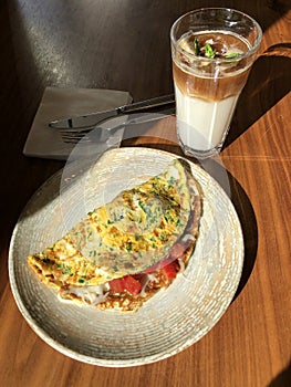 Omelet with vegetables and bacon and latte coffee