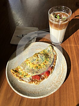 Omelet with vegetables and bacon and latte coffee