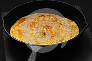Omelette in a cast iron frying pan photo