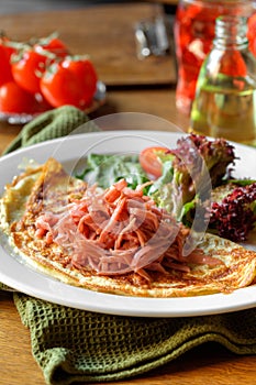 Omelette with chopped ham lettuce and tomatoes