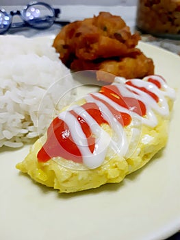 Omelette combined with white rice and cakes makes a fairly complete meal to enjoy. photo