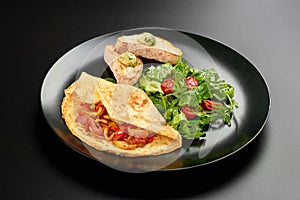 Omelette eggs fryed tomatoes rucola bread in a plate on dark background with copy space menu breakfast food