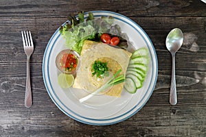 Omelette with fried rice in cafe on table