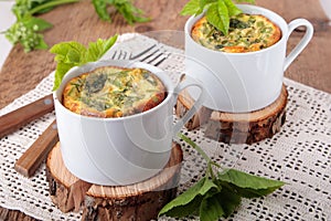 Omelette with goutweed in white ceramic cups