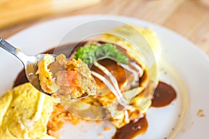 Omelette rice omurice in spoon with white dish japanese food