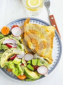 Omelette with salad and lemon water breakfast meal