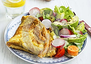 Omelette with salad and lemon water breakfast meal