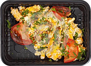Omelette with tomatoes rectangular plastic black lunch box top view on white background