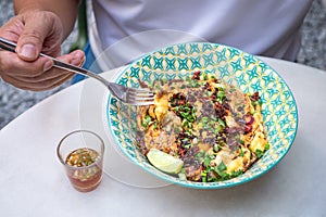 Omelette on top of bowl of rice, Thai style meal