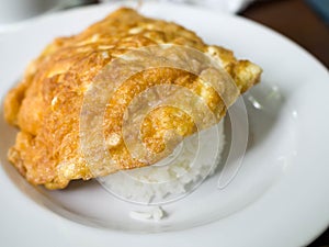 Omelette topped with rice