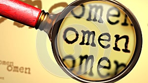 Omen - abstract concept and a magnifying glass enlarging English word Omen to symbolize studying, examining or searching for an