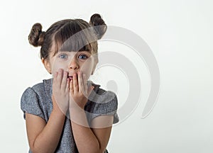 OMG! Happy surprised child 4 or 5 years old isolated on white. Oh no! Terrified shocked child with bugged eyes covers mouth with h