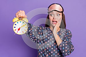 Omg unbelievable. Photo of shocked worried girl hold clock missed time touch hand face scream wear dotted pajama eye