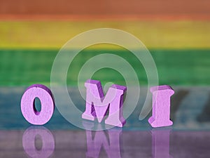 Omi inscription on wooden background of vintage boards in colors of lgbt flag