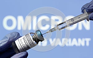 Omicron COVID-19 variant and corona virus vaccine, focus on bottle and syringe photo