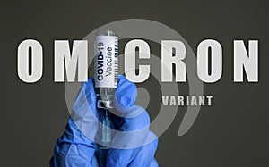 Omicron COVID-19 variant poster, vaccine bottle and syringe in doctor hands photo