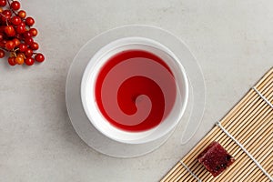 Omija tea Omija cha also known as schizandra tea in white bowl, top view. Brewed with schisandra berry